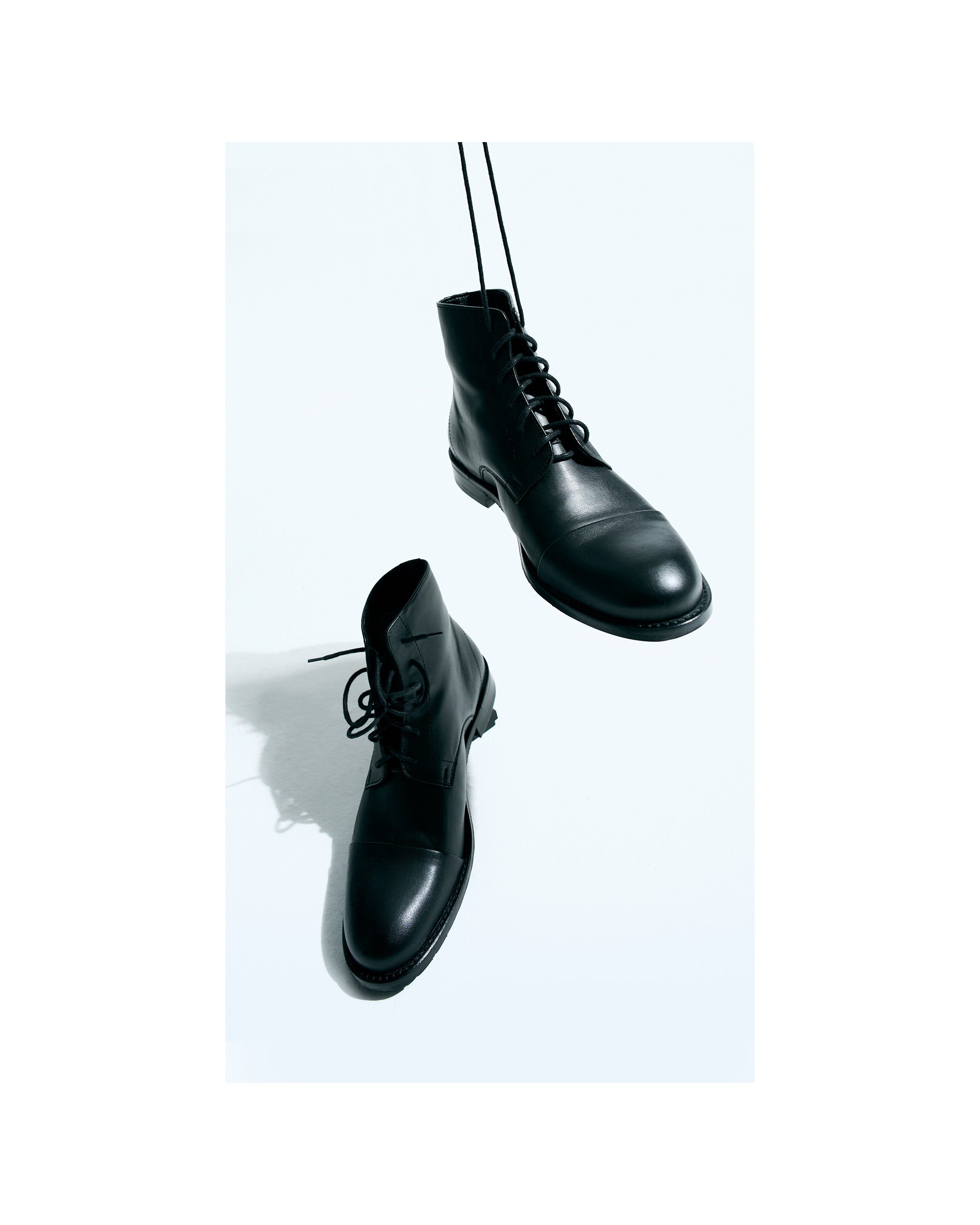 BOHEMA Laced-Up Ankle Boots in black - side view of women's lace-up ankle boots