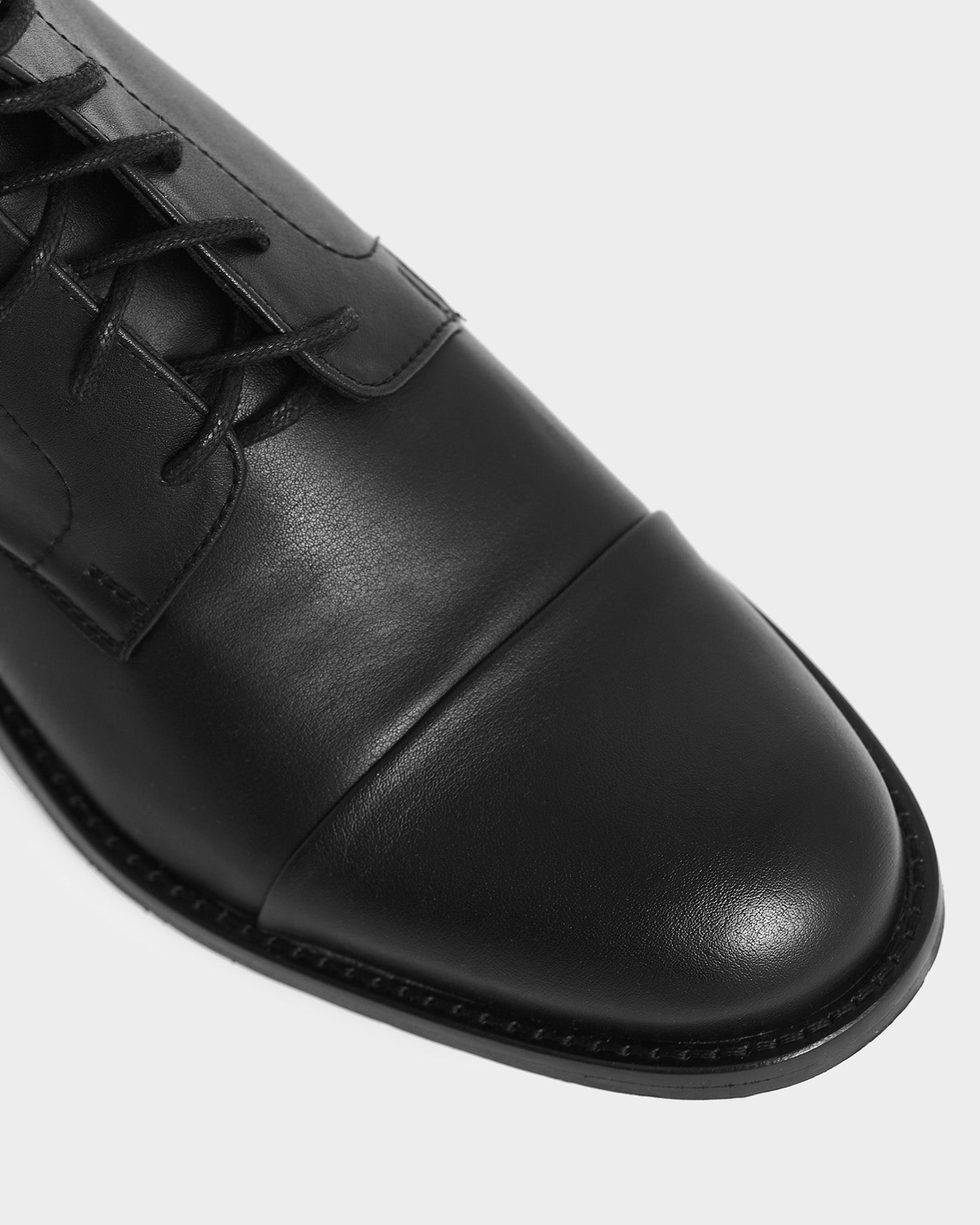 BOHEMA Laced-Up Ankle Boots in black - worn on foot of women's lace-up ankle boots