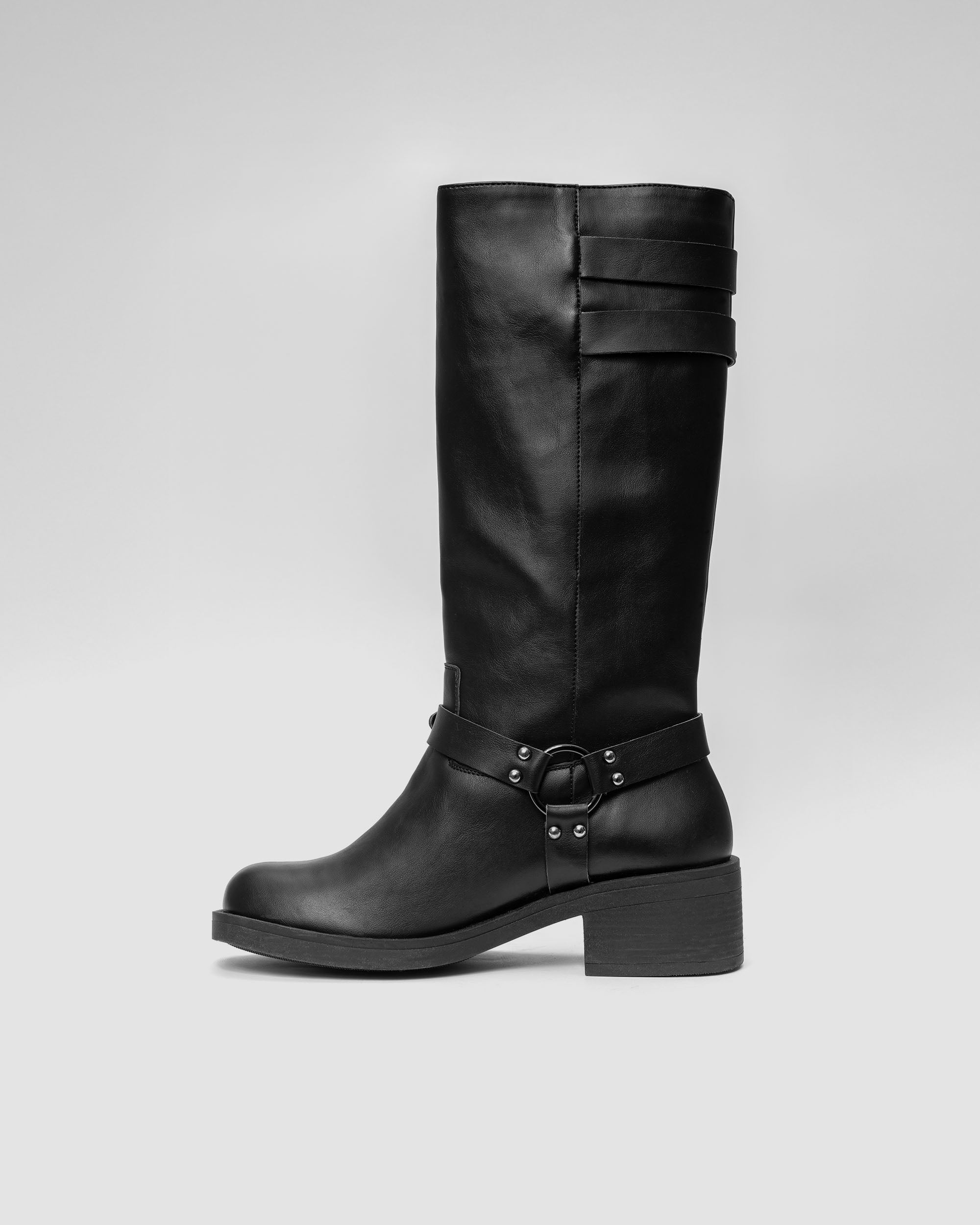 Modern black vegan leather biker boot with harness detail by BOHEMA on a neutral background