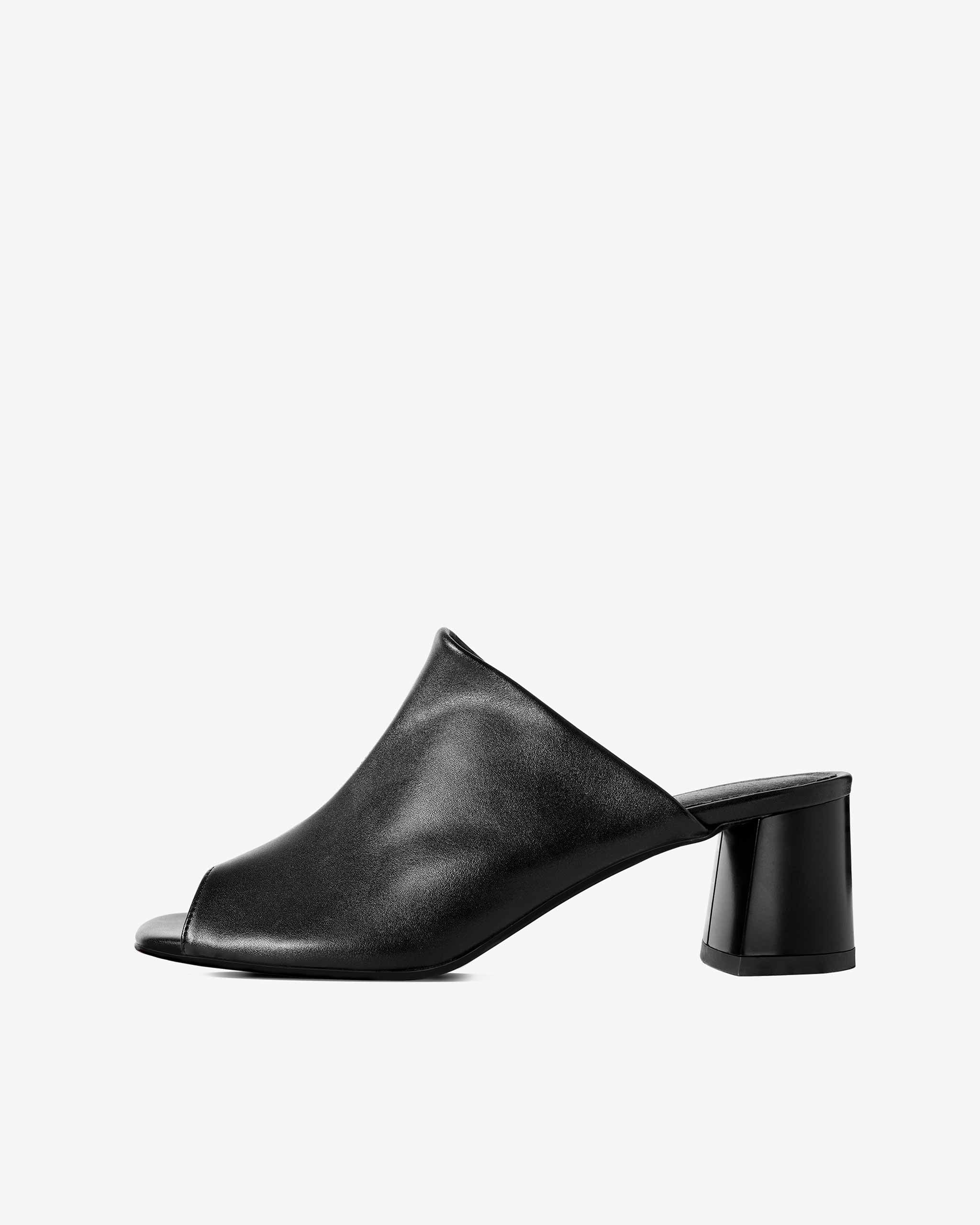 Black open-toe mule with low block heel, modern design, plant-based material, side view